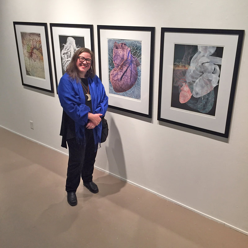 That's me, Kim-Lee Kho, standing with four large format digital mixed media prints from my 'A Full Heart' series, now showing in Rock, Paper, Scissors, a fascinating group show on now at the Living Arts Centre in Mississauga, through March 17, 2019. Photo: Kal Honey